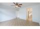 Bedroom with tile flooring, a ceiling fan, neutral paint, and an ensuite bath at 42432 W North Star Dr, Maricopa, AZ 85138