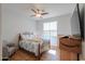 This cozy bedroom features natural light and a stylish ceiling fan at 42432 W North Star Dr, Maricopa, AZ 85138