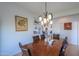 Traditional dining room boasts decorative chandelier, wainscoting, and seating for six at 42432 W North Star Dr, Maricopa, AZ 85138