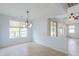 Dining area featuring a chandelier, tile flooring, neutral paint, and backyard views at 42432 W North Star Dr, Maricopa, AZ 85138