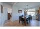 Charming dining room with tile floors, decorative chandelier, and view to backyard at 42432 W North Star Dr, Maricopa, AZ 85138