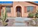 Welcoming home with arched entryway and desert landscaping at 42432 W North Star Dr, Maricopa, AZ 85138