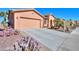 Inviting home featuring desert landscaping and a spacious driveway leading to a two-car garage at 42432 W North Star Dr, Maricopa, AZ 85138