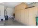 This spacious garage offers plenty of storage space with built-in cabinets at 42432 W North Star Dr, Maricopa, AZ 85138