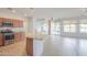 Open kitchen with stainless steel appliances and views to a patio and pond at 42432 W North Star Dr, Maricopa, AZ 85138
