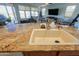 Kitchen sink on island with granite countertop and view into living room at 42432 W North Star Dr, Maricopa, AZ 85138