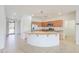 Open kitchen with island, granite counters, stainless appliances, and tile flooring at 42432 W North Star Dr, Maricopa, AZ 85138