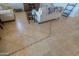 Close-up of tile floor in living room with furniture visible at 42432 W North Star Dr, Maricopa, AZ 85138