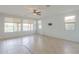 Bright living room with tile flooring, neutral walls, and backyard views at 42432 W North Star Dr, Maricopa, AZ 85138