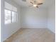 Bright living room with neutral walls, a ceiling fan, and a large window with natural light at 42432 W North Star Dr, Maricopa, AZ 85138