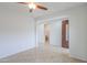 Spacious living area with tile flooring offering an entrance view and a peek into a bathroom at 42432 W North Star Dr, Maricopa, AZ 85138