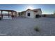 Large backyard with low maintenance landscaping featuring covered patio and outdoor storage at 4511 S 181St Ave, Goodyear, AZ 85338