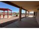 View from under the covered patio area to the sparkling pool and backyard at 4511 S 181St Ave, Goodyear, AZ 85338