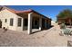 Stucco home featuring covered patio, rock landscaping, and a paved path to a pergola at 4511 S 181St Ave, Goodyear, AZ 85338