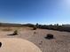 Spacious backyard with rock landscaping, fire pit, and mountain views at 4511 S 181St Ave, Goodyear, AZ 85338