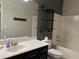 Bathroom featuring a single sink vanity with a dark cabinet, a large mirror and a combined tub and shower at 4511 S 181St Ave, Goodyear, AZ 85338