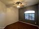 Cozy bedroom with a ceiling fan, wood floors, and a picture window at 4511 S 181St Ave, Goodyear, AZ 85338