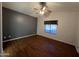 An empty bedroom with vaulted ceilings, a ceiling fan and wood-look floors and a window at 4511 S 181St Ave, Goodyear, AZ 85338