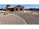 View of home with a red-tiled roof, circular driveway, and desert-friendly xeriscaping at 4511 S 181St Ave, Goodyear, AZ 85338