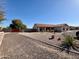 A quaint residence features a circular driveway with drought-resistant landscaping at 4511 S 181St Ave, Goodyear, AZ 85338