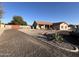 Single Gathering home featuring desert landscaping, terracotta colored roof, and large circular driveway at 4511 S 181St Ave, Goodyear, AZ 85338