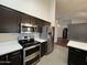 Close up of stainless steel appliances and white countertop in a modern kitchen at 4511 S 181St Ave, Goodyear, AZ 85338