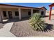 Desert landscaping, including rock ground cover, and a walkway lead to the covered patio at 4511 S 181St Ave, Goodyear, AZ 85338