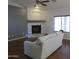 Bright living room featuring modern fireplace, hardwood floors, and neutral colored walls and furniture at 4511 S 181St Ave, Goodyear, AZ 85338