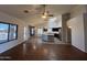 Spacious open-concept living area with hardwood floors, stone accent wall, and modern kitchen island at 4511 S 181St Ave, Goodyear, AZ 85338