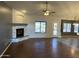 Open-concept living area showcasing hardwood floors, a fireplace, and neutral-toned walls at 4511 S 181St Ave, Goodyear, AZ 85338