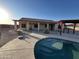 An inground pool with desert landscaping and a pergola offer backyard entertainment at 4511 S 181St Ave, Goodyear, AZ 85338