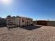 Detached shed with new paint and gravel landscaping providing additional storage at 4511 S 181St Ave, Goodyear, AZ 85338