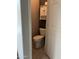 View of the toilet room featuring tile floors, toilet, cabinets, and an access door at 4511 S 181St Ave, Goodyear, AZ 85338