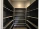 Walk-in closet with ample shelving space for optimal storage and organization at 4511 S 181St Ave, Goodyear, AZ 85338