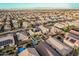 Panoramic aerial view of a neighborhood showcasing homes with solar panels and private backyard pools at 4521 W Maggie Dr, San Tan Valley, AZ 85144