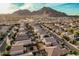 Stunning aerial perspective of a residential area with pools, landscaping, and a picturesque mountain backdrop at 4521 W Maggie Dr, San Tan Valley, AZ 85144