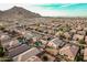 Aerial view showcasing mountain views and a neighborhood with houses featuring backyards and swimming pools at 4521 W Maggie Dr, San Tan Valley, AZ 85144