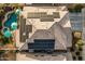 Aerial view of house with solar panels and backyard pool with umbrellas at 4521 W Maggie Dr, San Tan Valley, AZ 85144