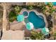 Aerial view of backyard pool and spa, lush landscaping, and vibrant umbrellas at 4521 W Maggie Dr, San Tan Valley, AZ 85144