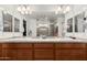 Bathroom featuring double sinks, wood cabinets, and a large mirror at 4521 W Maggie Dr, San Tan Valley, AZ 85144