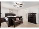 Spacious bedroom featuring a cozy bench, a dark wood bed frame, and bright windows at 4521 W Maggie Dr, San Tan Valley, AZ 85144