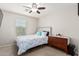 Bedroom features white walls, ceiling fan, bed, and dresser at 4521 W Maggie Dr, San Tan Valley, AZ 85144