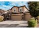 Charming two-story home with a three car garage with stone accents and landscaped front yard at 4521 W Maggie Dr, San Tan Valley, AZ 85144