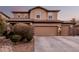 Charming two-story home with a three car garage and meticulously landscaped front yard at dusk at 4521 W Maggie Dr, San Tan Valley, AZ 85144