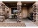 Inviting front porch with decorative stone pillars, seating, and a well-maintained entrance at 4521 W Maggie Dr, San Tan Valley, AZ 85144