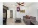 Comfortable living room featuring tile flooring, a gray sofa, and a dart board at 4521 W Maggie Dr, San Tan Valley, AZ 85144