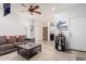 Spacious living room features a gray couch, decorative accents, and modern tile floors at 4521 W Maggie Dr, San Tan Valley, AZ 85144