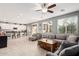 Open concept living room with a large sofa, a center table and a view of the breakfast bar and kitchen at 4521 W Maggie Dr, San Tan Valley, AZ 85144