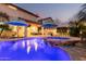 Inviting backyard pool and spa with blue umbrellas, perfect for relaxation and entertaining at 4521 W Maggie Dr, San Tan Valley, AZ 85144