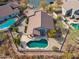 An aerial view shows the sparkling backyard pool, covered patio, and lush landscaping at 4665 S Palacio Way, Gold Canyon, AZ 85118